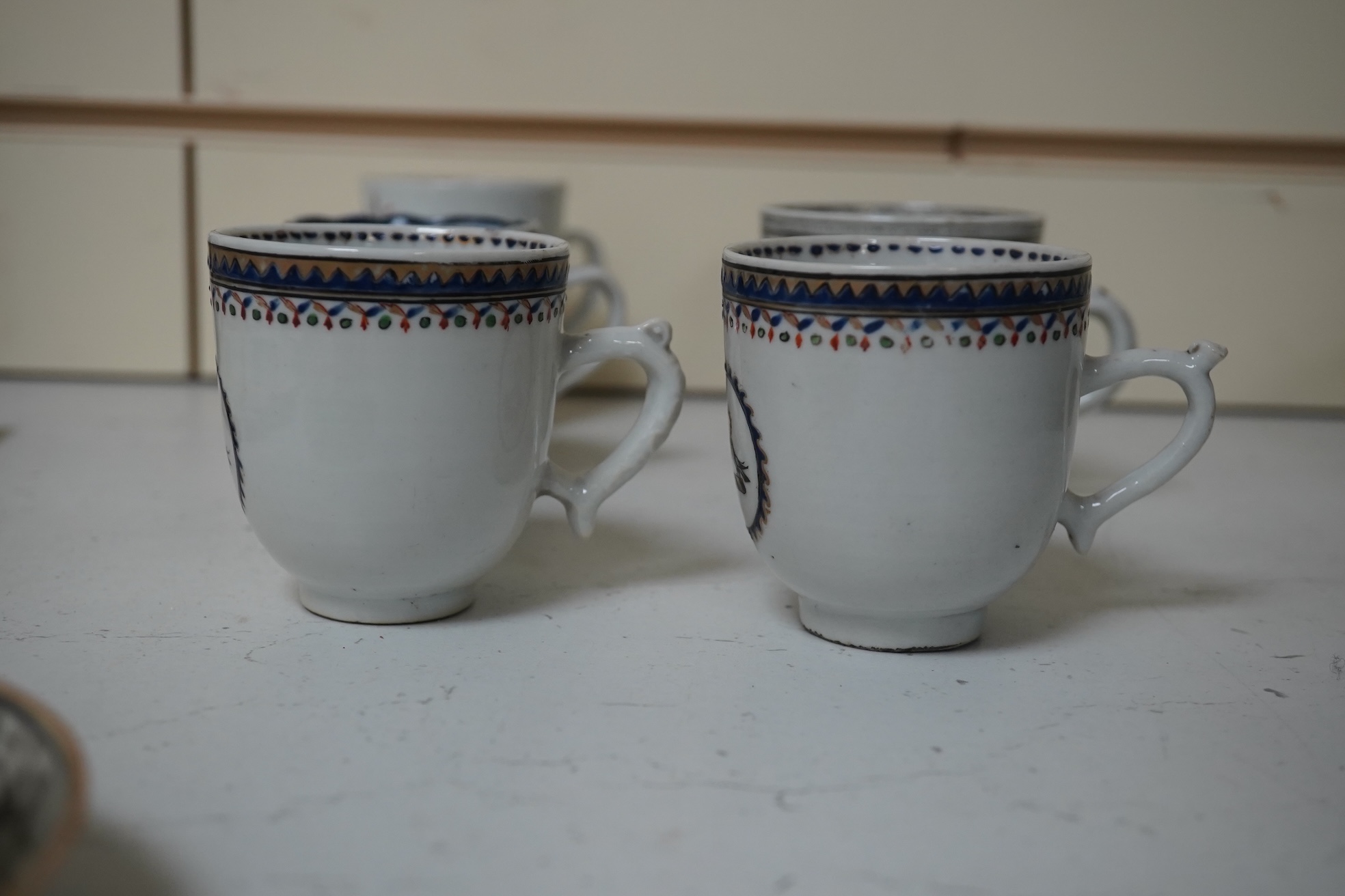 Six assorted 18th century Chinese export coffee cups with armorial decoration, and a similar European subject cup and saucer. Condition - damaged/restored